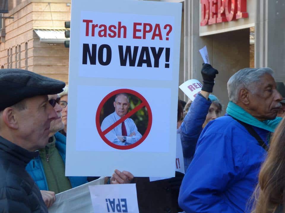 Protestors and sign with picture of Scott Pruitt saying "Trash EPA - no way"